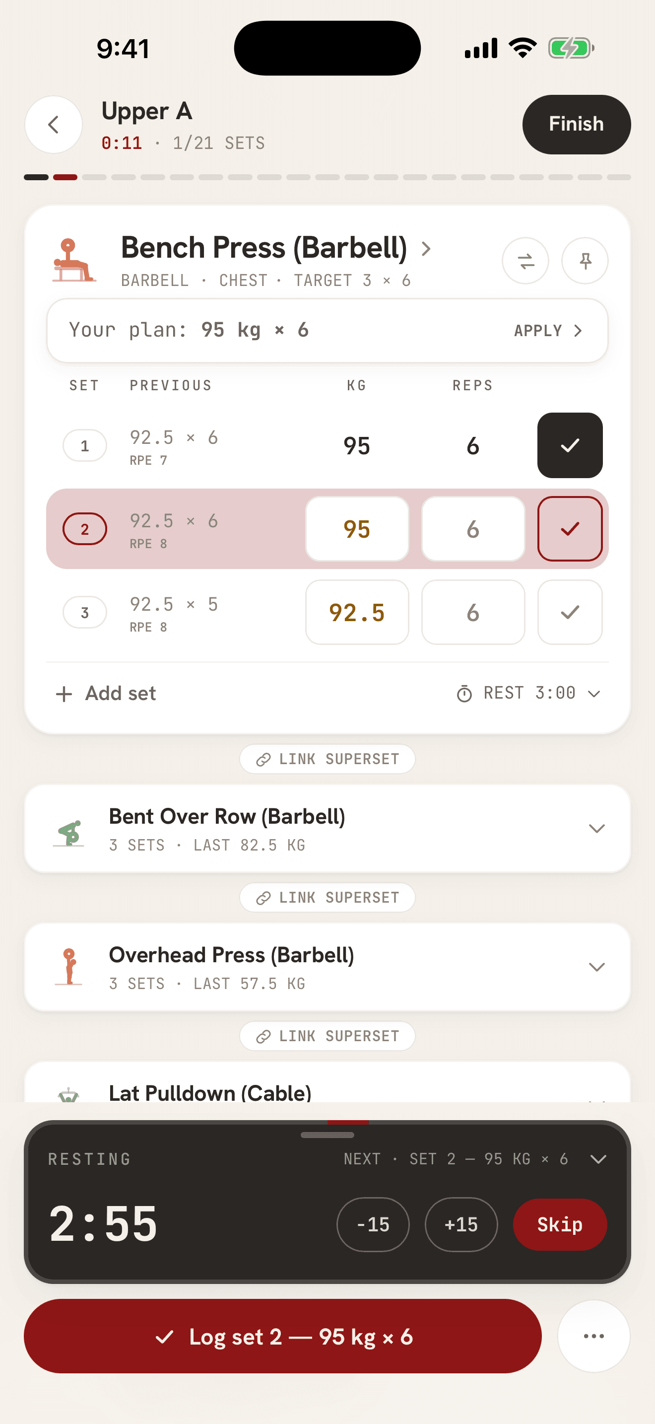 Workout logger: set rows with weight, reps and RPE, the plan for the next set, and the rest timer counting down